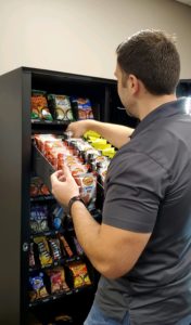 Owner of Royal Vending Joseph Catalanotto Filling a Snack Machine at a Hotel in New Orleans